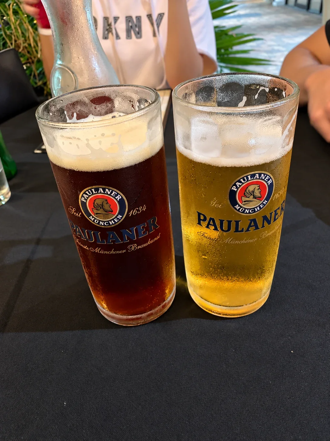 Golden and dark beers in tall glasses on the table at Ararat
