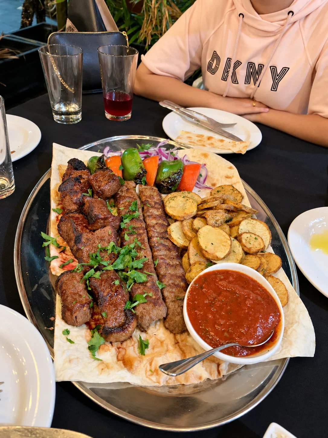 A mixed grill with skewered and minced meats, potatoes, peppers, onions and flatbread at Ararat
