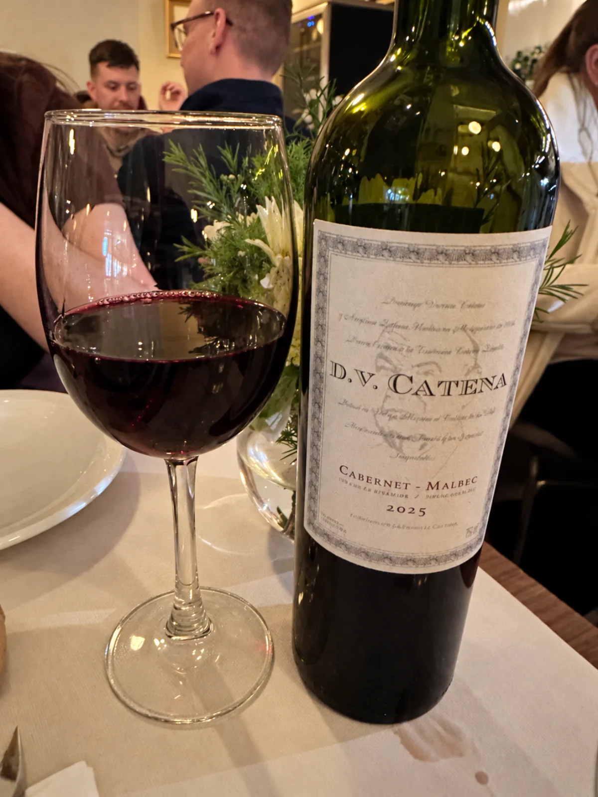 A wine bottle and a glass of red wine at our La Alacena Trattoria dinner