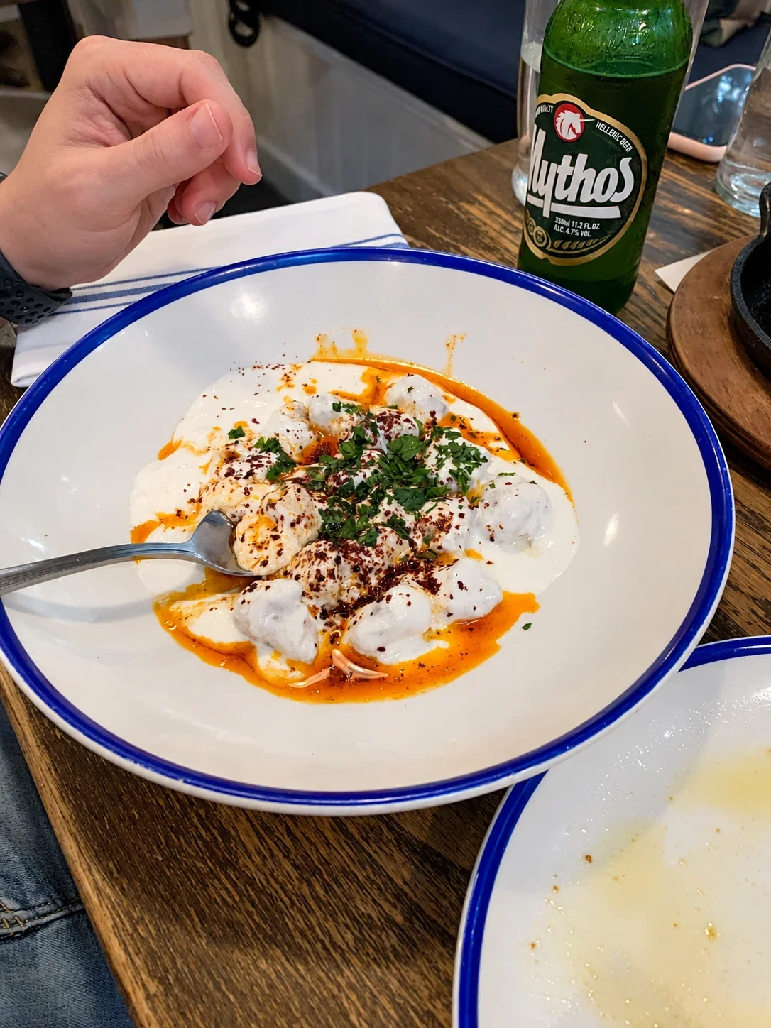 Mantı dumplings coated with garlic yogurt, orange butter and pepper at Mandolin Aegean Bistro