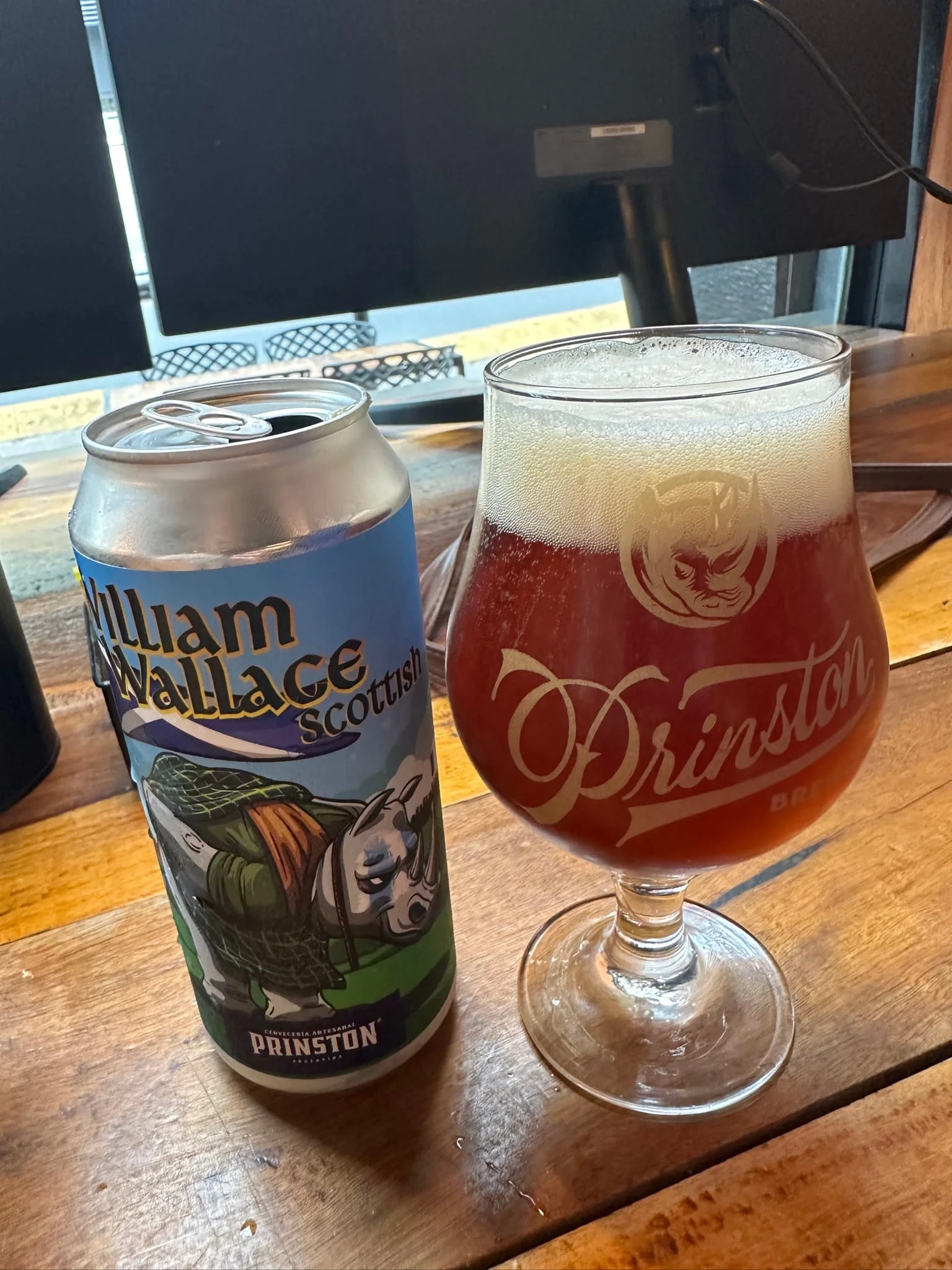 Prinston William Wallace Scottish beer in a can beside a glass of amber beer